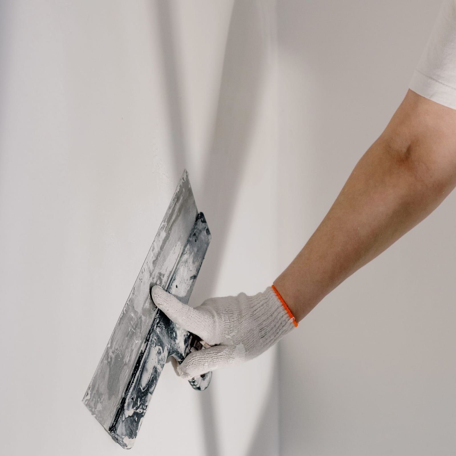 Wall texture being worked to match the surrounding finish after a patch