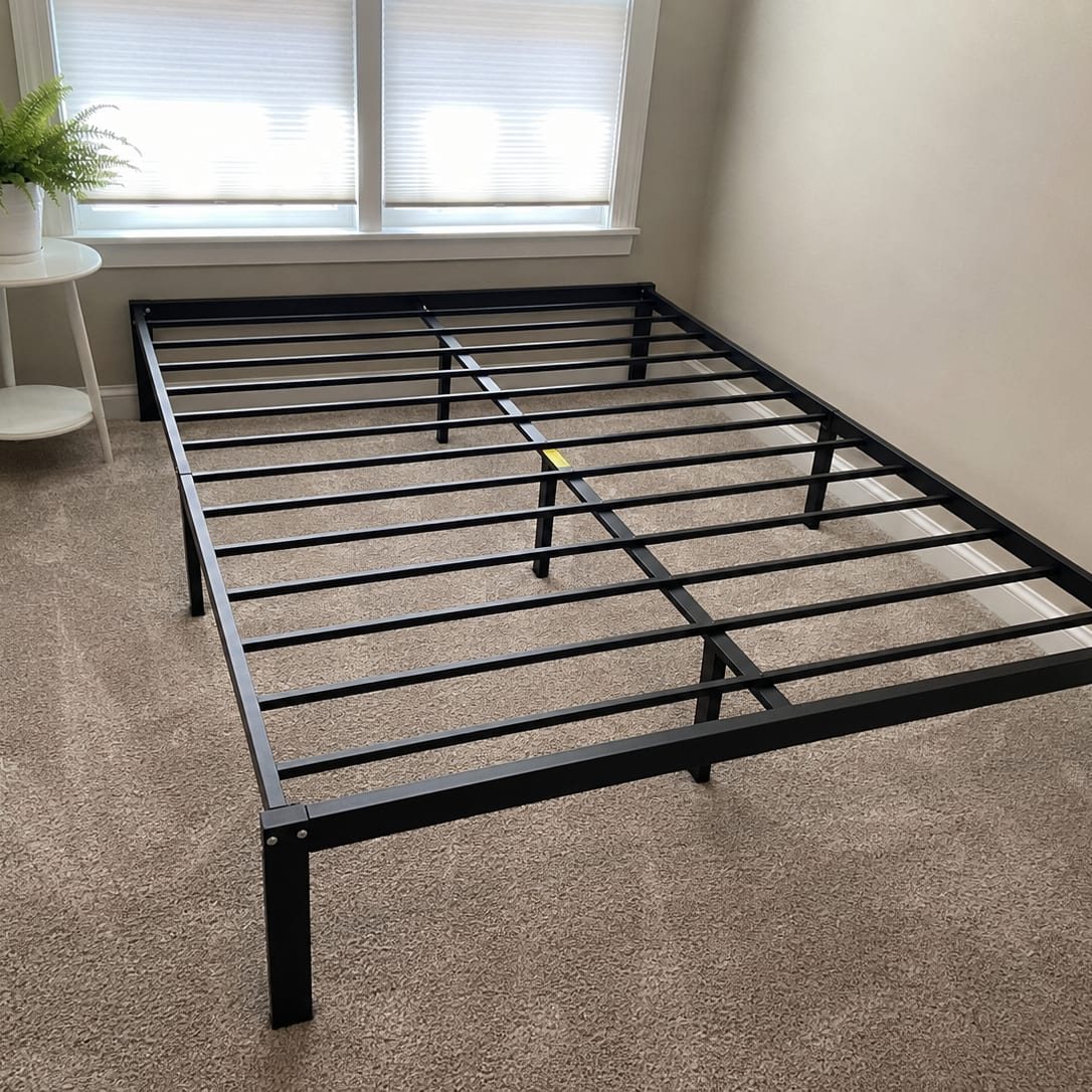 Metal bed frame assembled and standing square on the bedroom floor