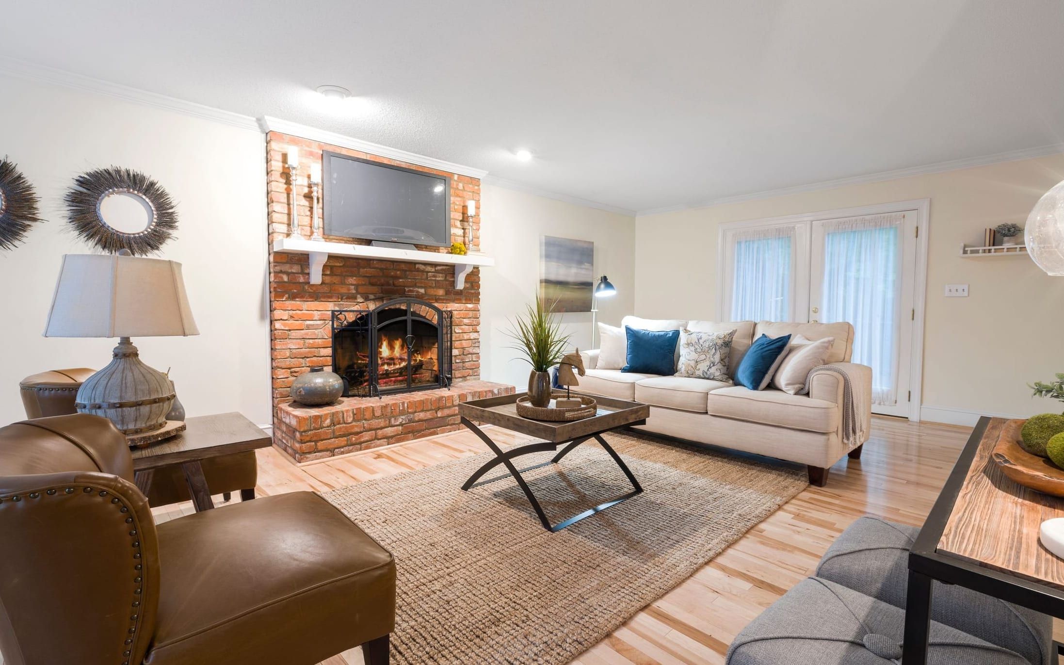Living room fully furnished with sofa, chairs, and tables after a multi-piece setup