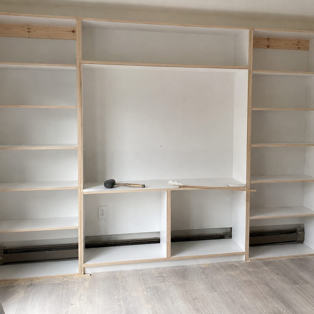 Tall shelving unit built square and standing flat against the wall