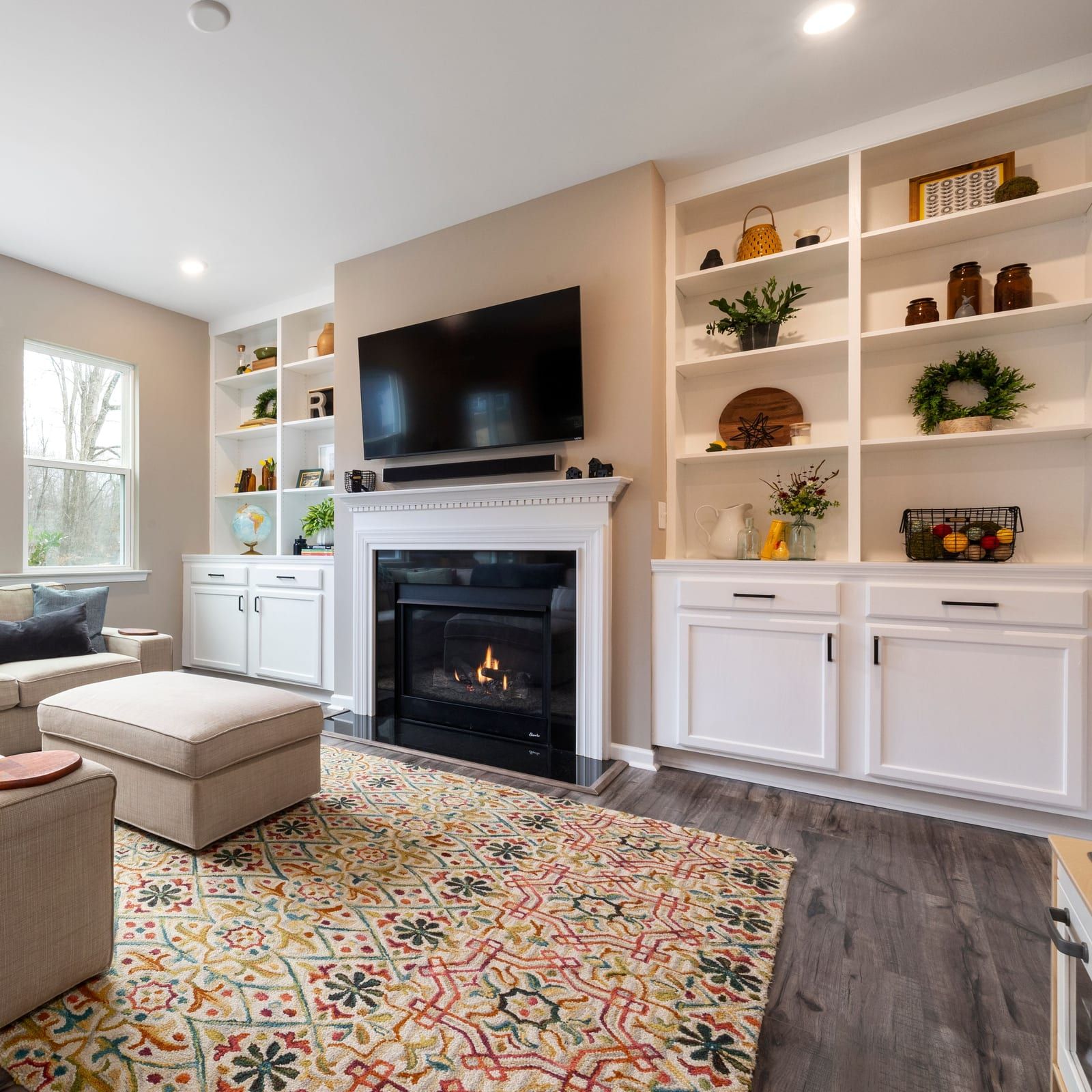 Finished living room with built-in shelving and a fireplace, the kind of space our work is part of