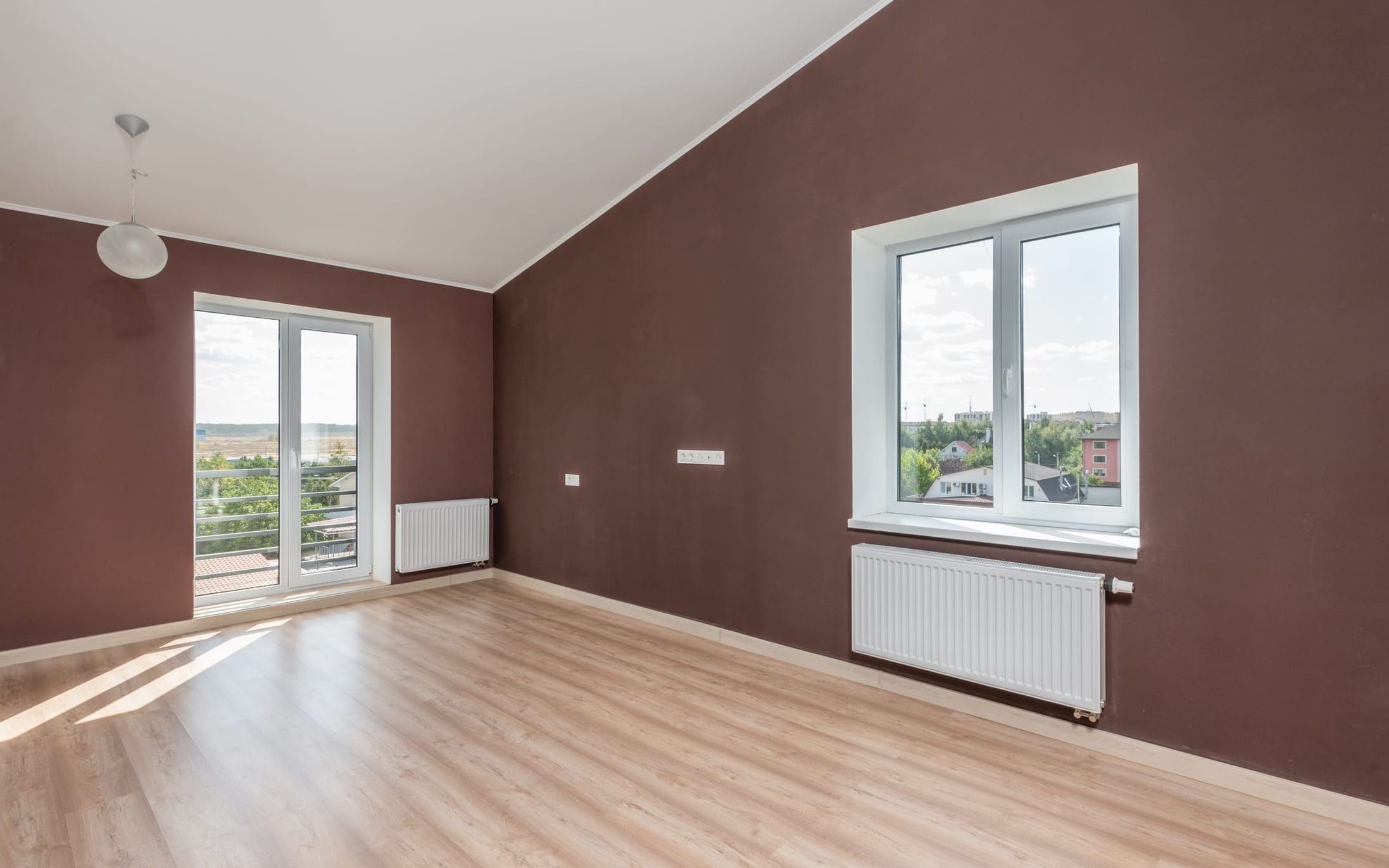 Empty room with a dark accent wall and bare floors ready for the final walkthrough