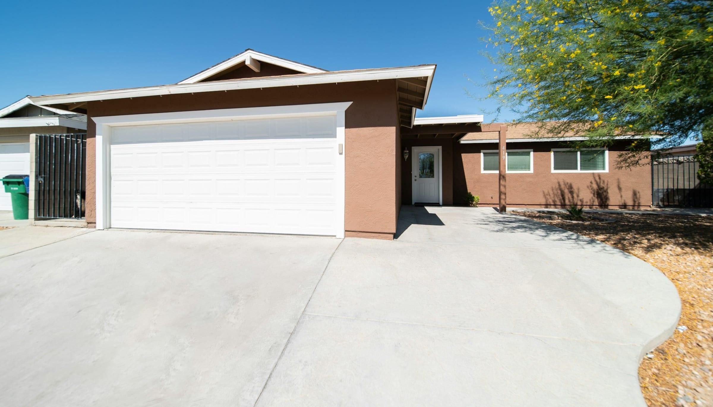 Clean concrete driveway in front of a single-family home