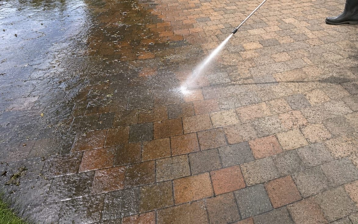 Brick paver patio being washed, showing the contrast between clean and dirty sections