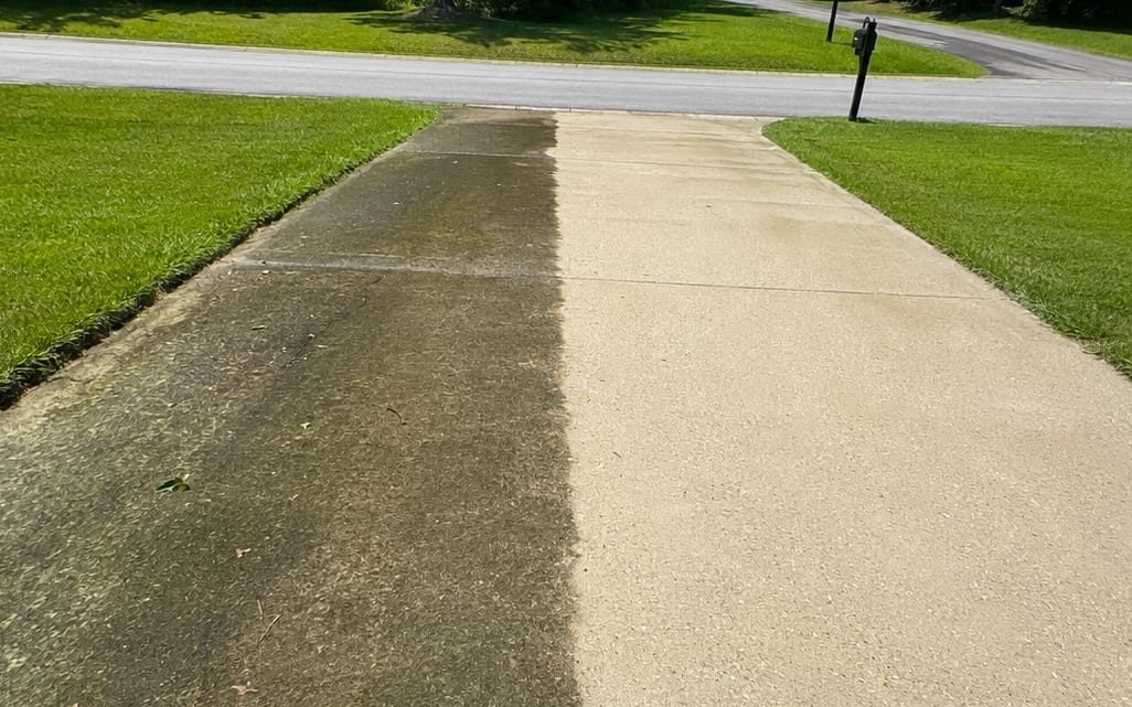 Sidewalk half washed showing the clean side against the weathered side